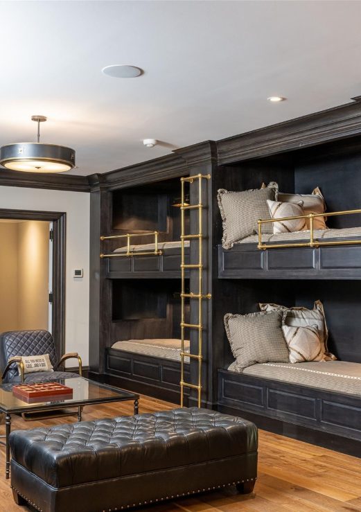 Four built-in bunks in a black stain with brass rails