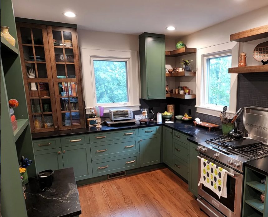 Painted green kitchen with a stained glass-front hutch