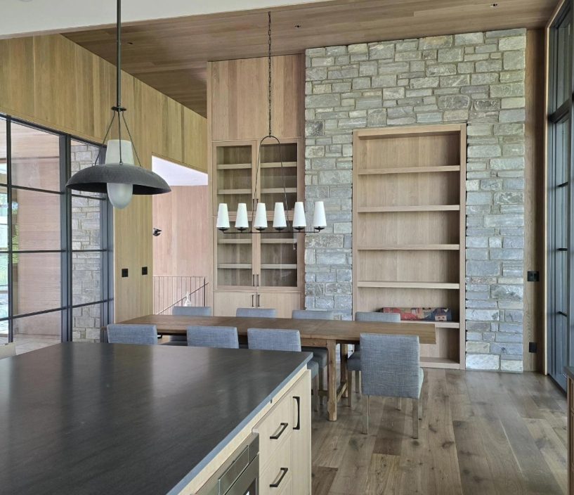 Oak china cabinet and shelving set into a stone wall