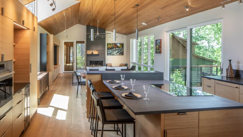 Rift oak slab-door kitchen under a vaulted wood ceiling