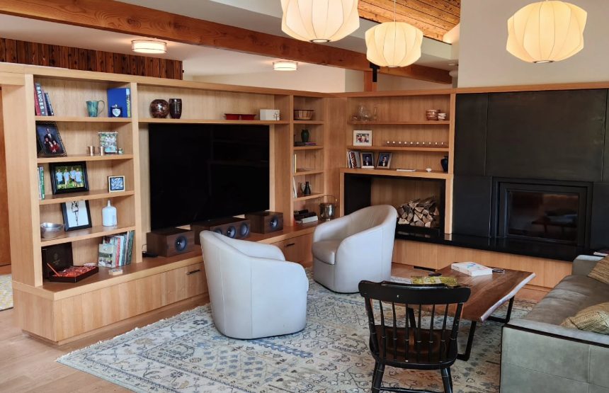 White oak shelving around the TV and firewood nook